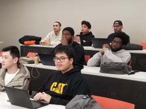 "San Francisco Bay University students listen to Tomer Singal, a software engineer from Google, during their computer science capstone class."