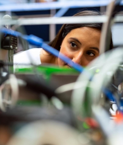 Photo Of Female Engineer Looking Through Wires