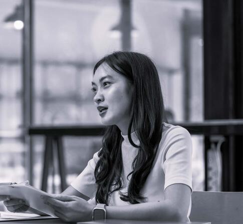 Two females having a discussion at a desk.