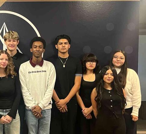 Scholar students in standing and smiling for a group picture
