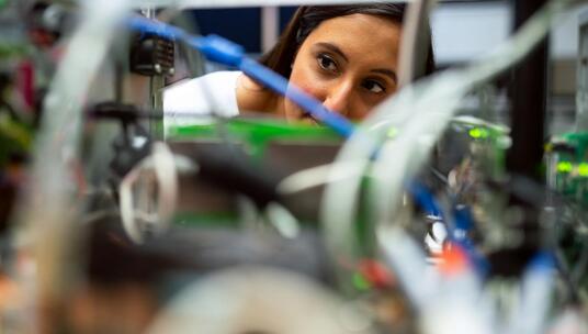 Photo Of Female Engineer Looking Through Wires